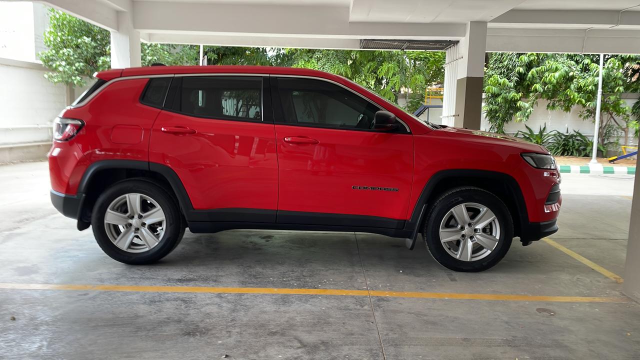 side view of a Exotic Red Jeep Compass