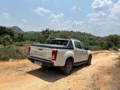 rear three-quarter of a Isuzu V-Cross on a dirt road