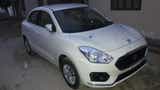 front three-quarter of a Arctic White Maruti Suzuki Dzire 2018-2023