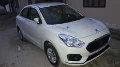 front three-quarter of a Arctic White Maruti Suzuki Dzire 2018-2023