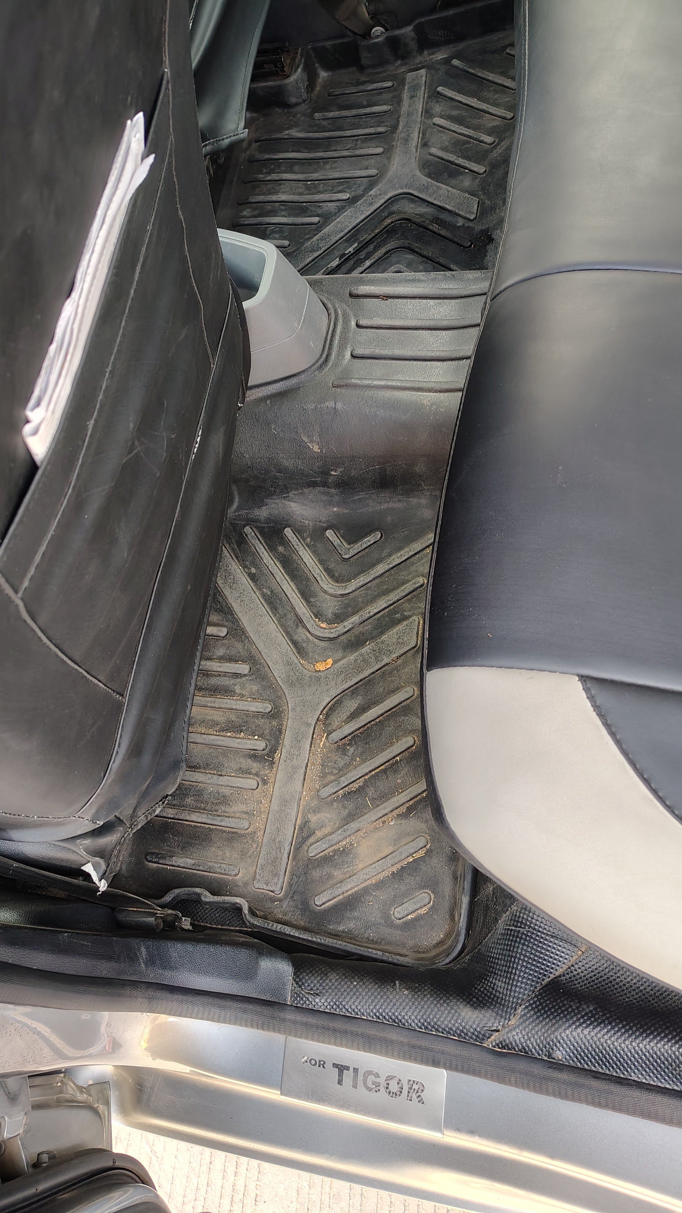 Rear seat and floor mat area of a Tata Tigor