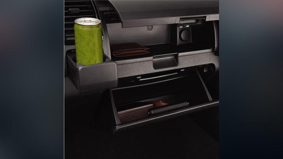 Interior dashboard storage and cupholder of an Isuzu S-CAB