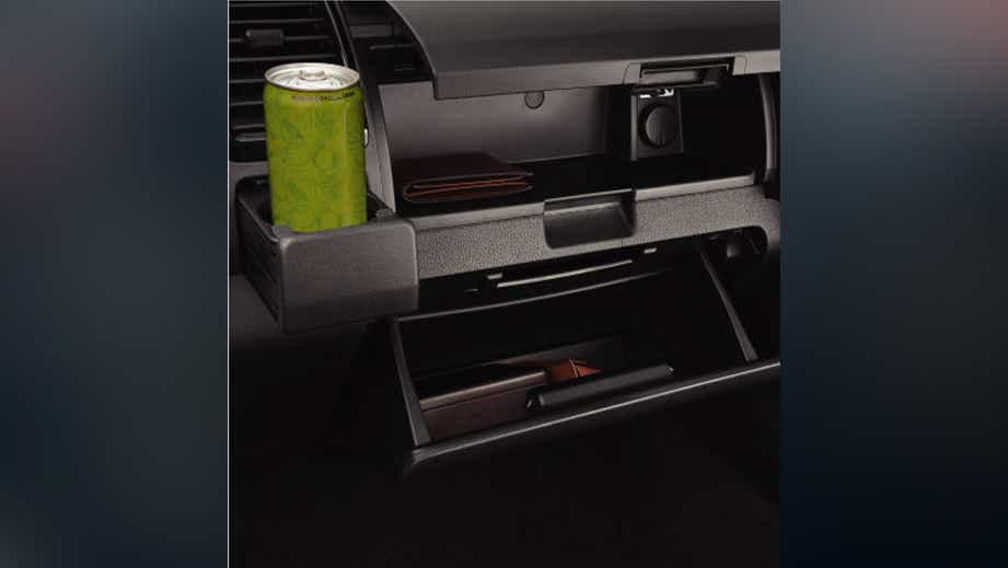 Interior dashboard storage and cupholder of an Isuzu S-CAB