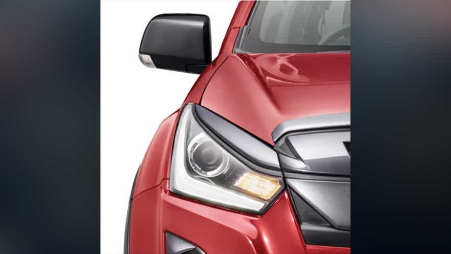 Headlight close-up of a Red Spinal Mica Isuzu V-Cross