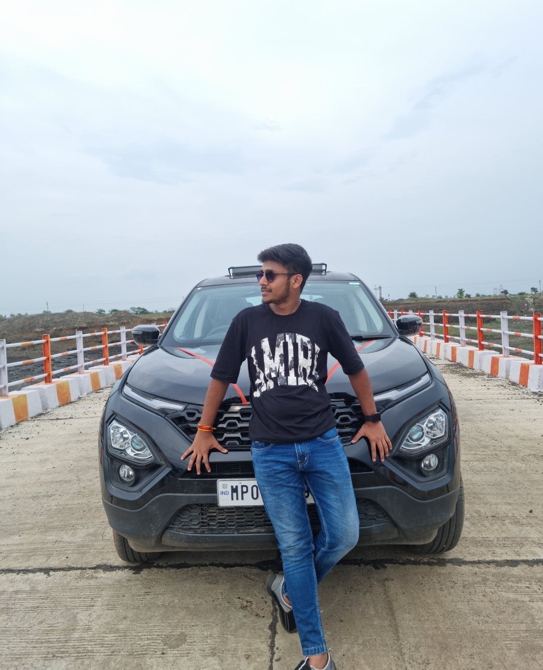 Front view of a Tata Harrier 2019-2023 with person posing