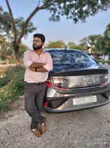 Rear view of a Hyundai Aura parked outdoors