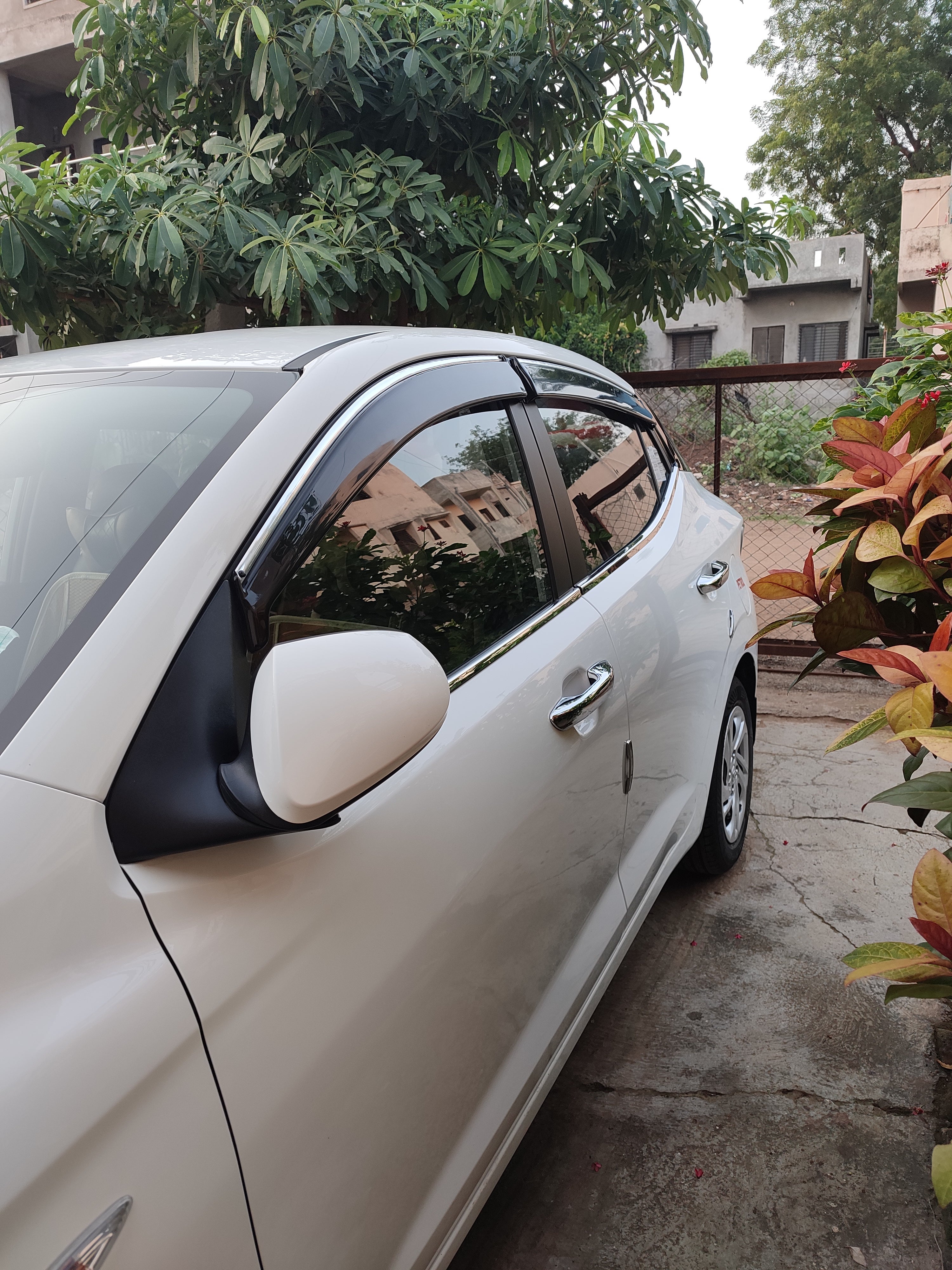 Side view of a Hyundai Aura parked outdoors