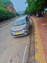 front three-quarter view of a Maruti Suzuki Ertiga parked on a roadside