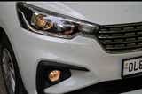 Front headlight and grille of a Maruti Suzuki Ertiga