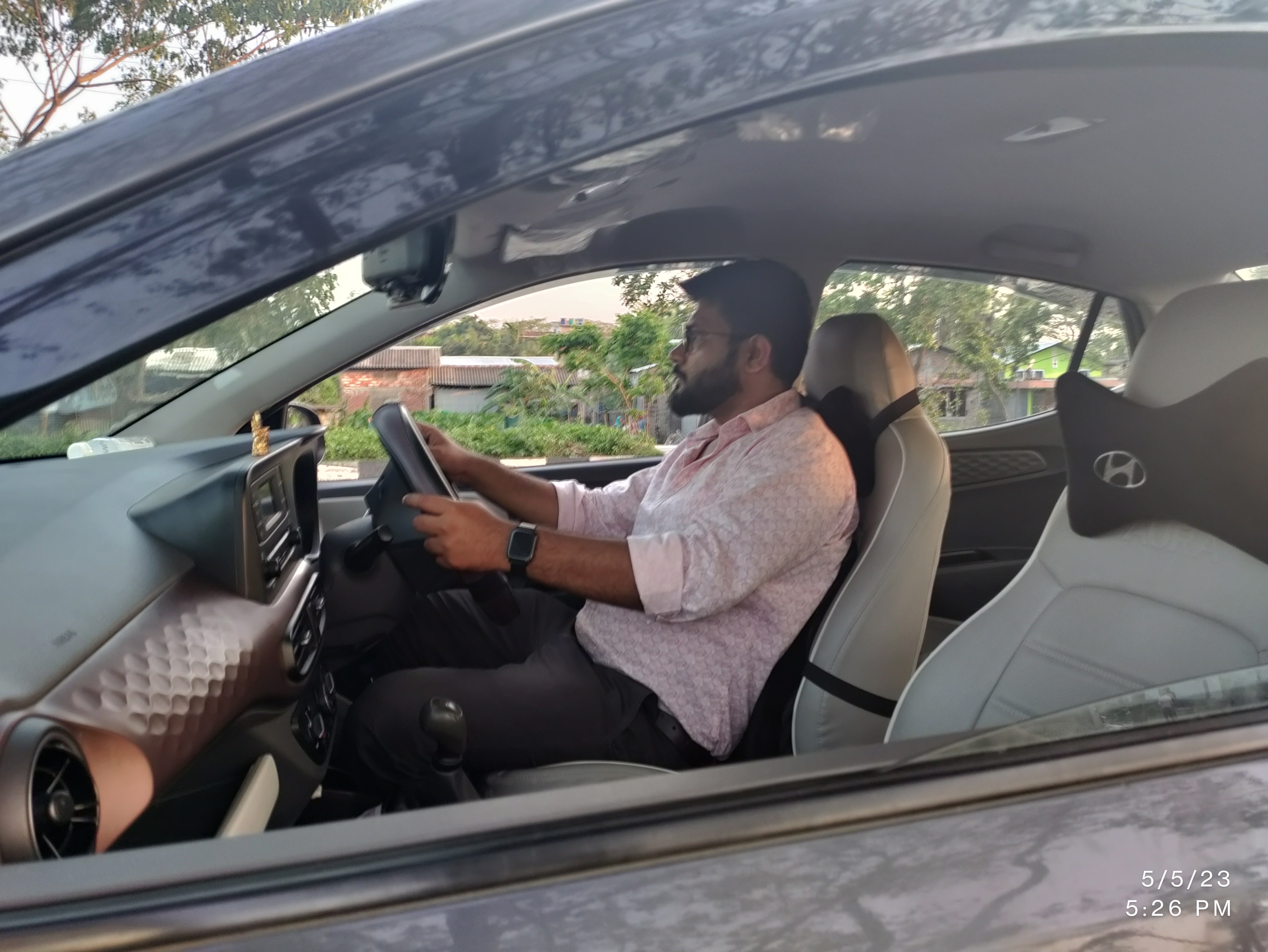 Driver-side interior view of a Hyundai Aura
