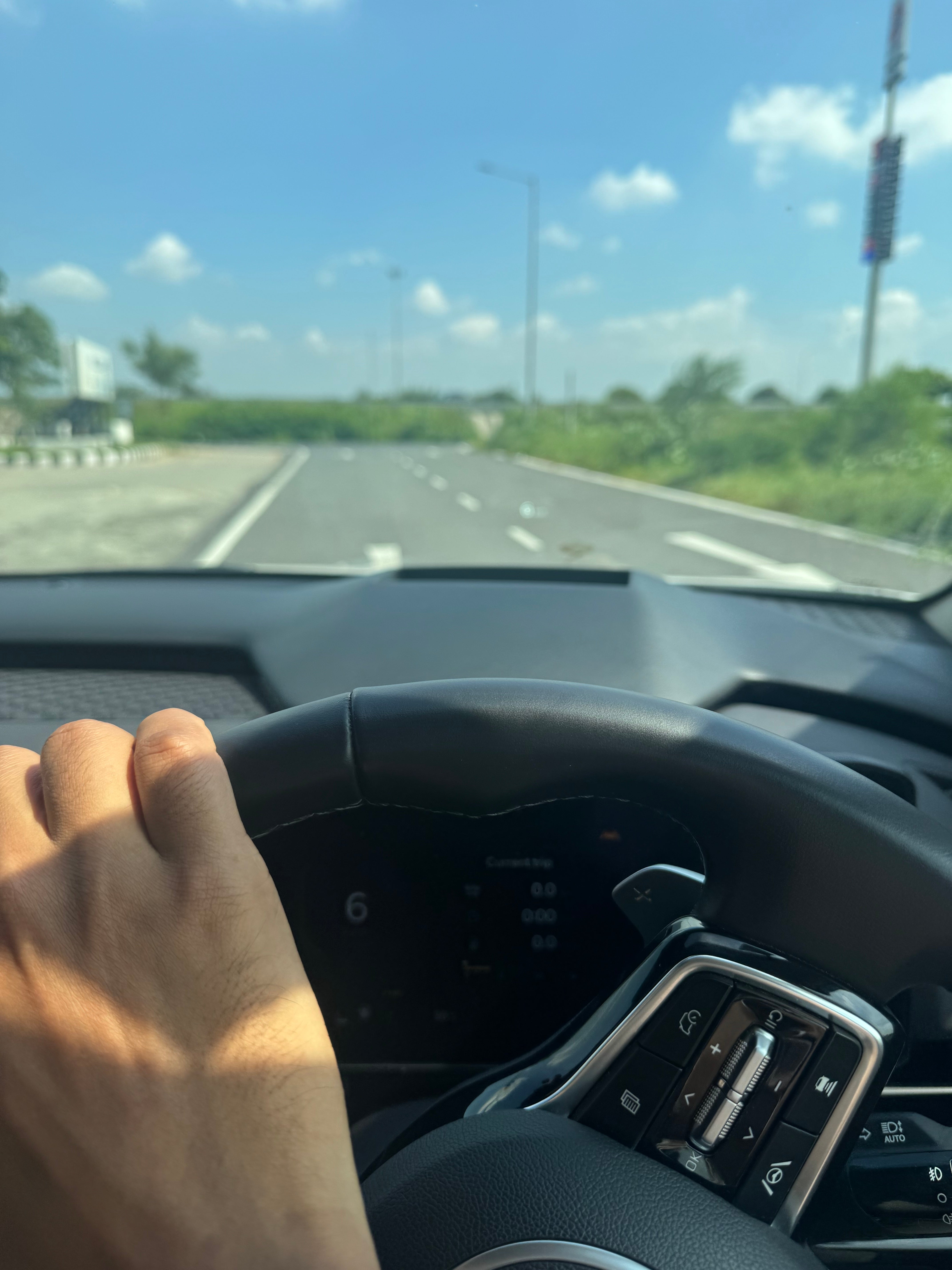 Interior view of a Kia Carnival steering wheel and dashboard
