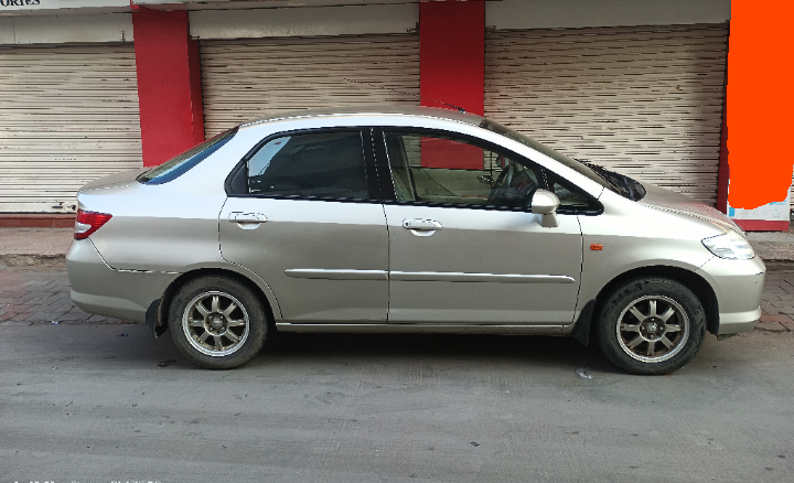 side view of a Honda City sedan parked on street