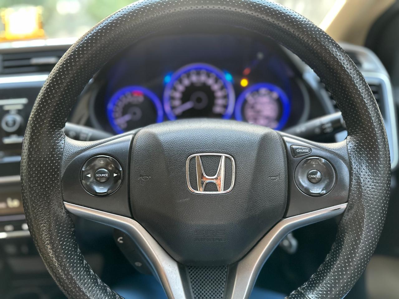 steering wheel and instrument cluster of a Honda City