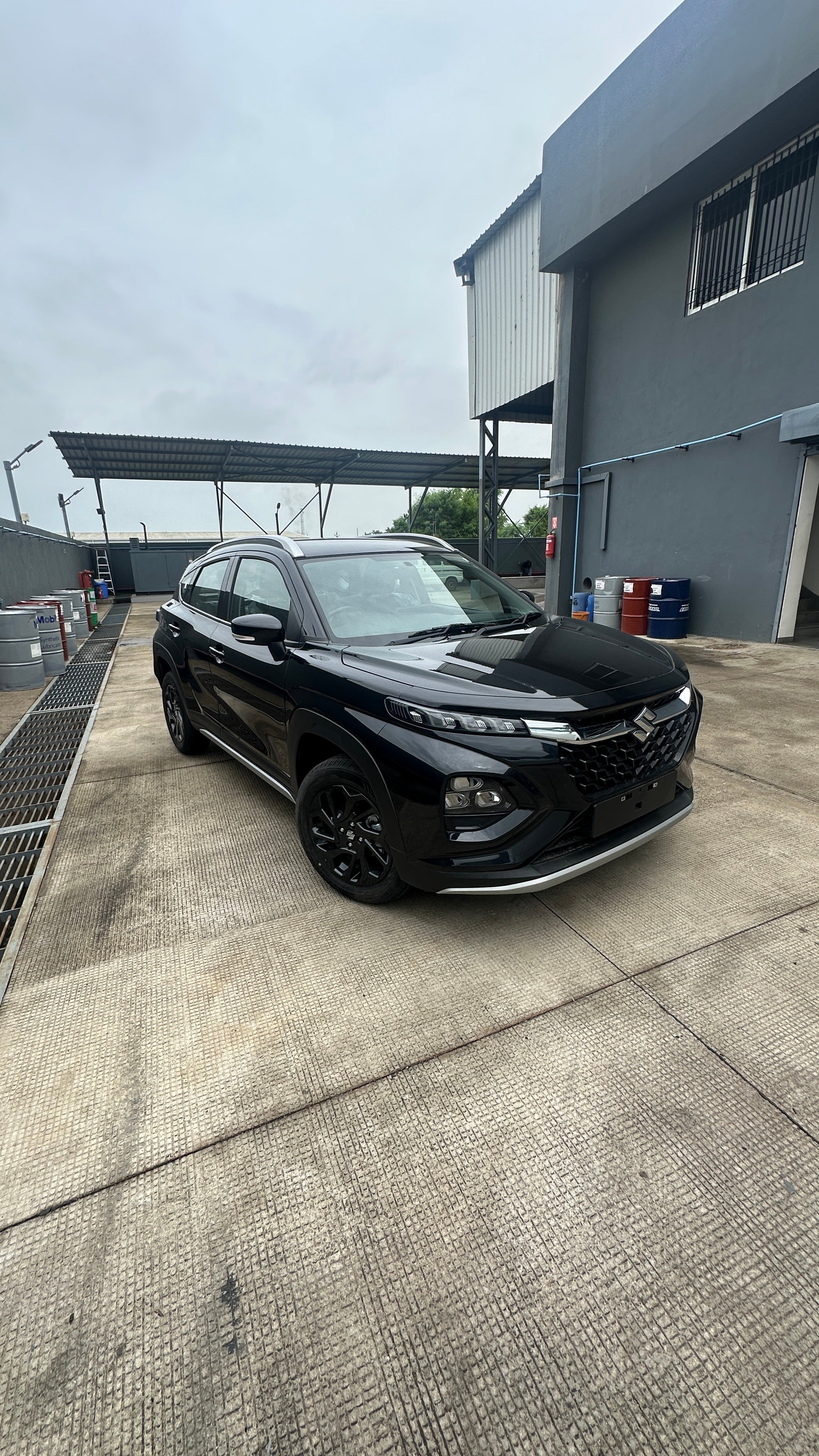 front three-quarter view of a Bluish Black Maruti Suzuki FRONX