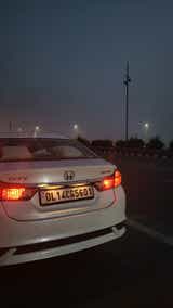 rear view of a Honda City on a city road at dusk