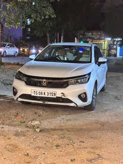 Front view of a Honda City parked outdoors at night