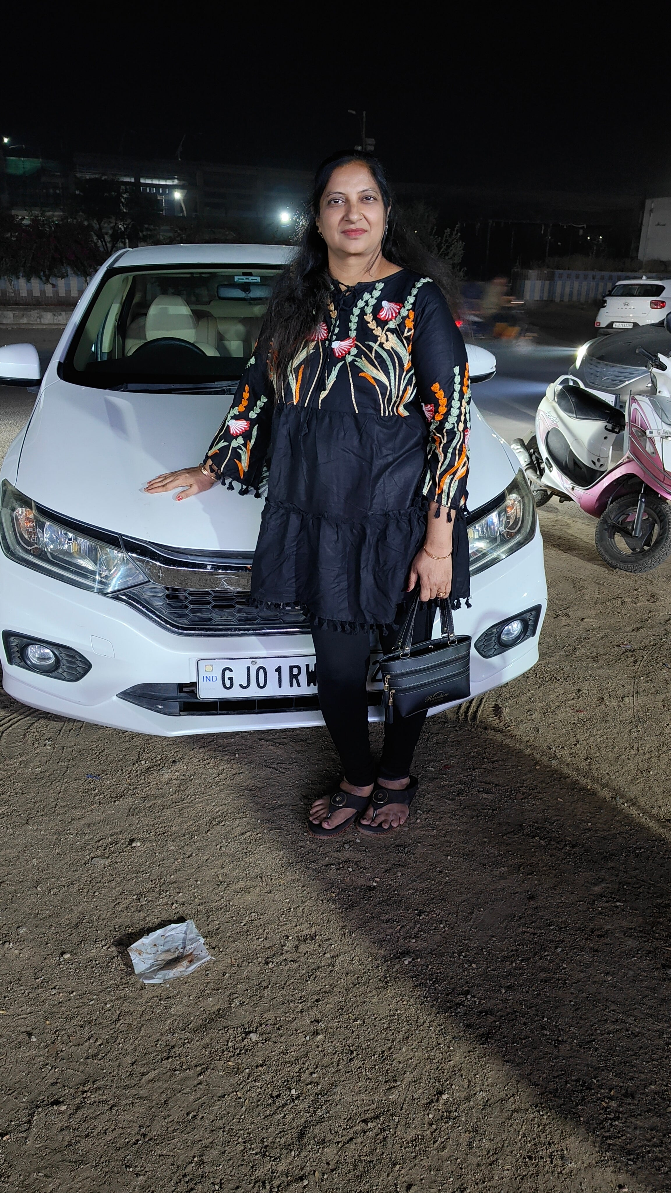 Front view of a Honda City with a person standing in front