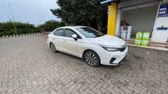 front three-quarter view of a Honda City sedan at a fuel station