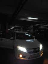Front view of a Honda City in a parking garage