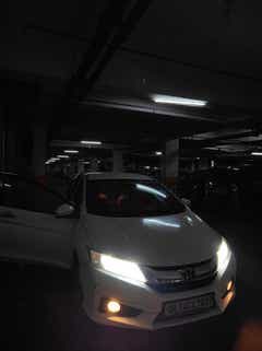 Front view of a Honda City in a parking garage
