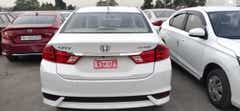 Rear view of a Honda City in a parking lot