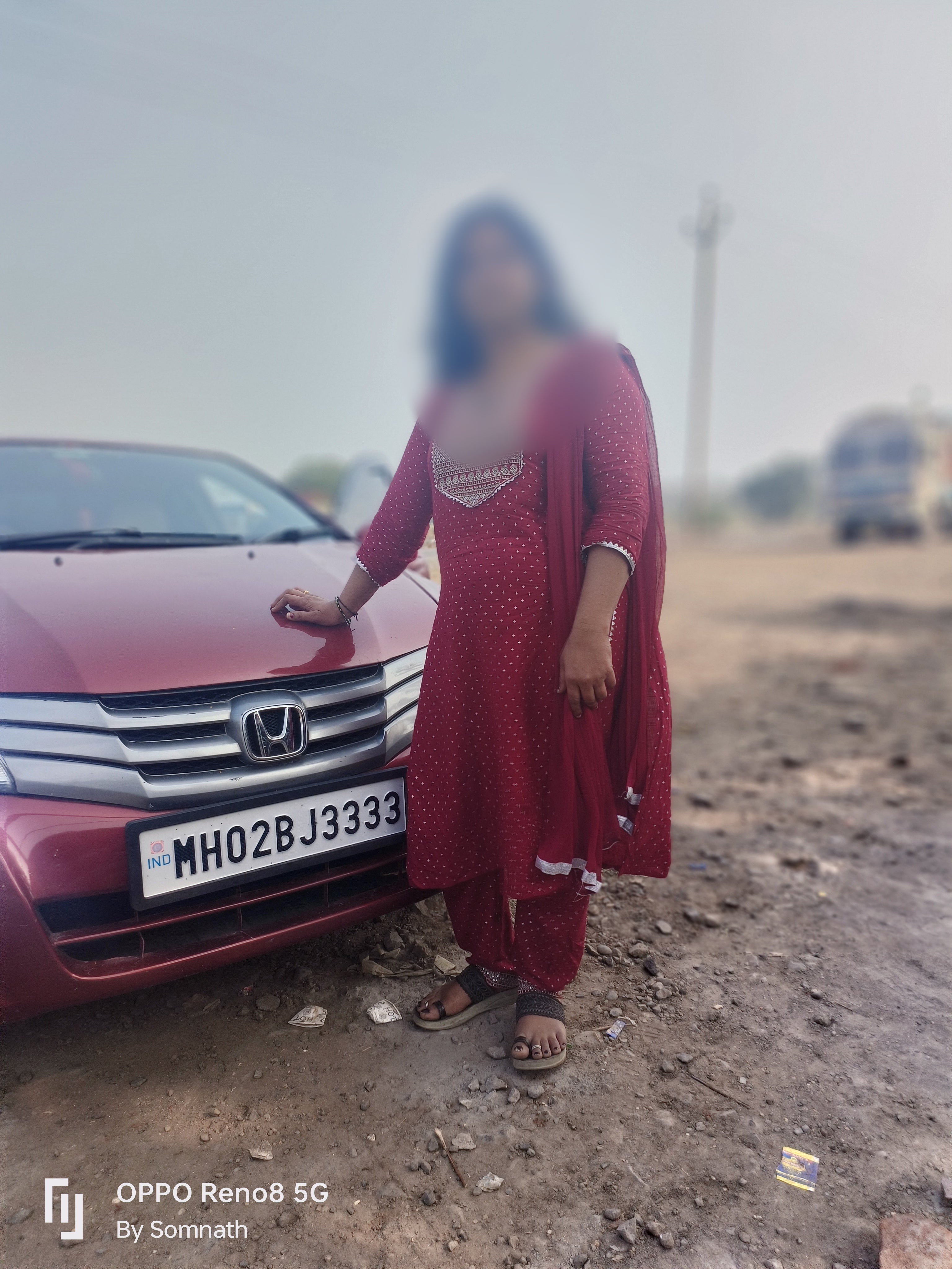 Front view of a Honda City with a person standing beside it