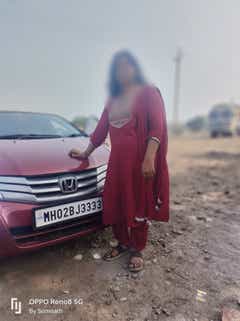 Front view of a Honda City with a person standing beside it