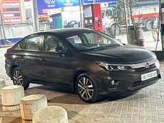 front three-quarter view of a Honda City at a fuel station