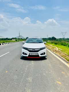 Front view of a Honda City on a highway