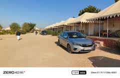 front three-quarter view of a Honda City parked near tents