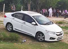 Front-side view of a Honda City sedan parked outdoors