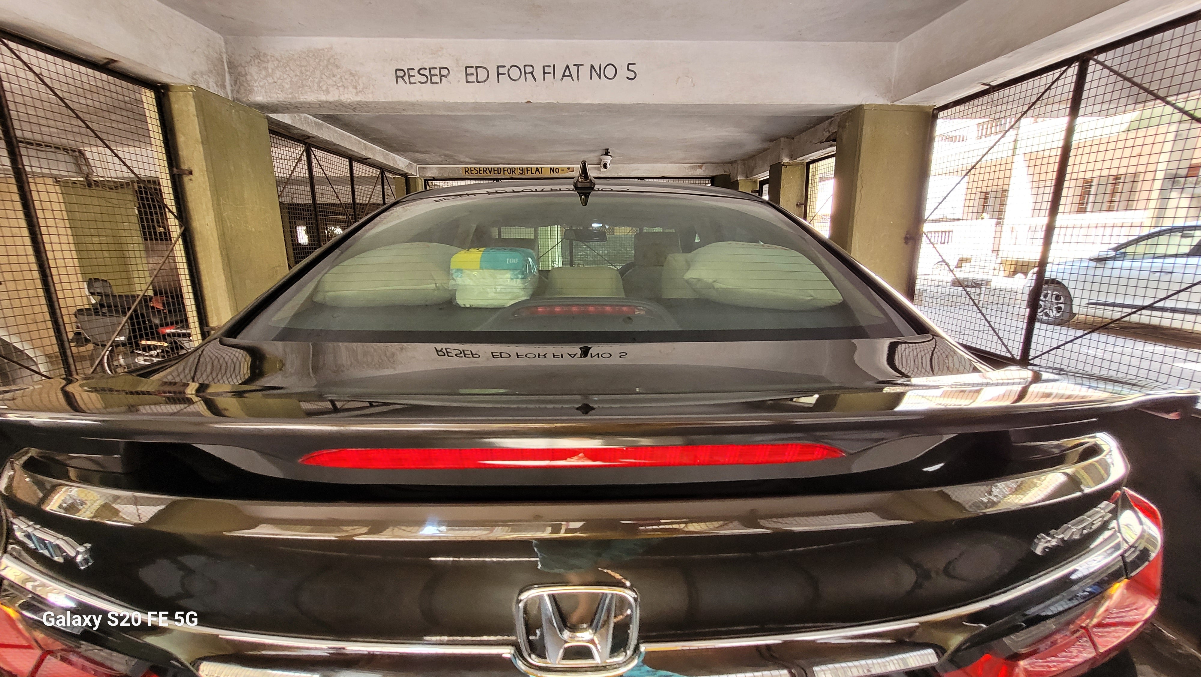 Rear view of a Honda City in a parking area