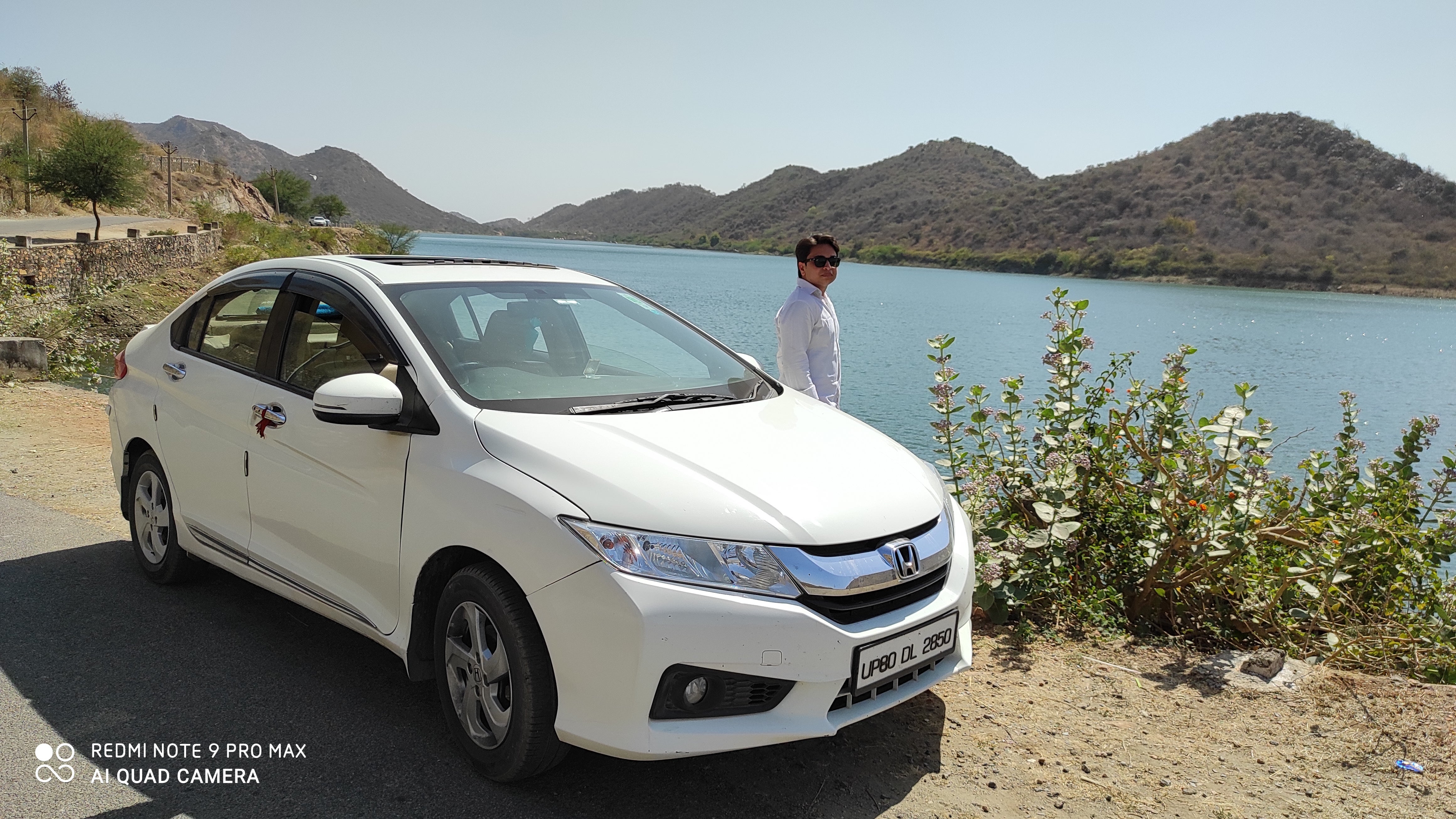 front three-quarter view of a Honda City near a riverbank