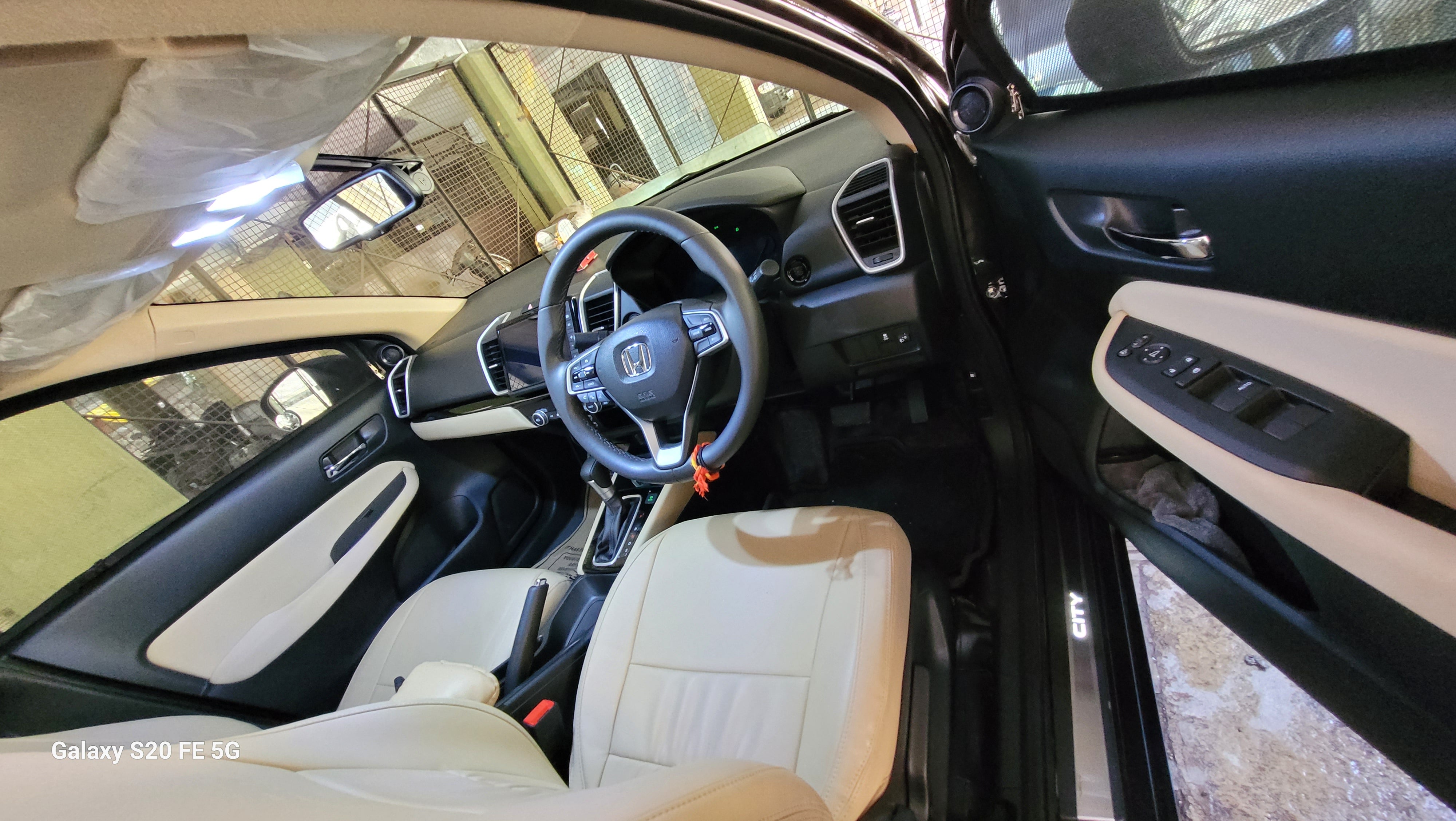 interior dashboard and front seats of a Honda City