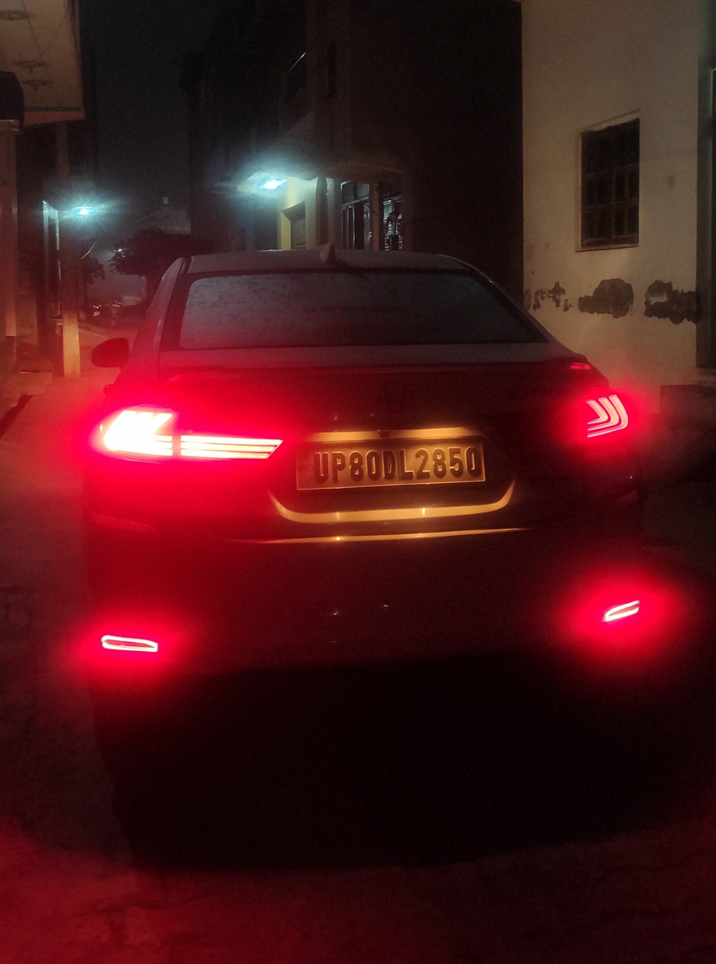Rear view of a Honda City at night