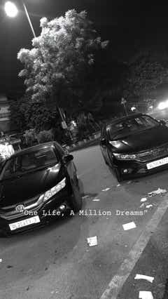 Front view of a Honda City parked on the street at night
