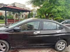side profile of a Honda City sedan parked outdoors