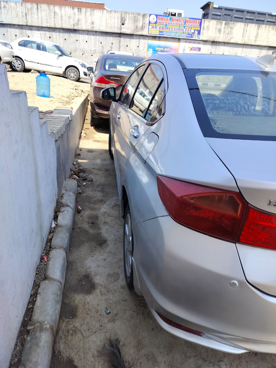 rear-side view of a Honda City parked outdoors