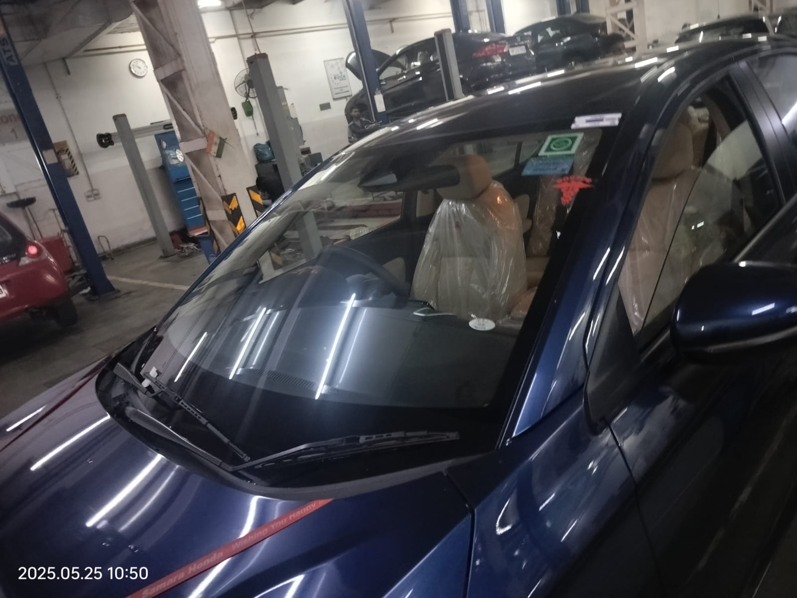front view of a Honda City in a workshop