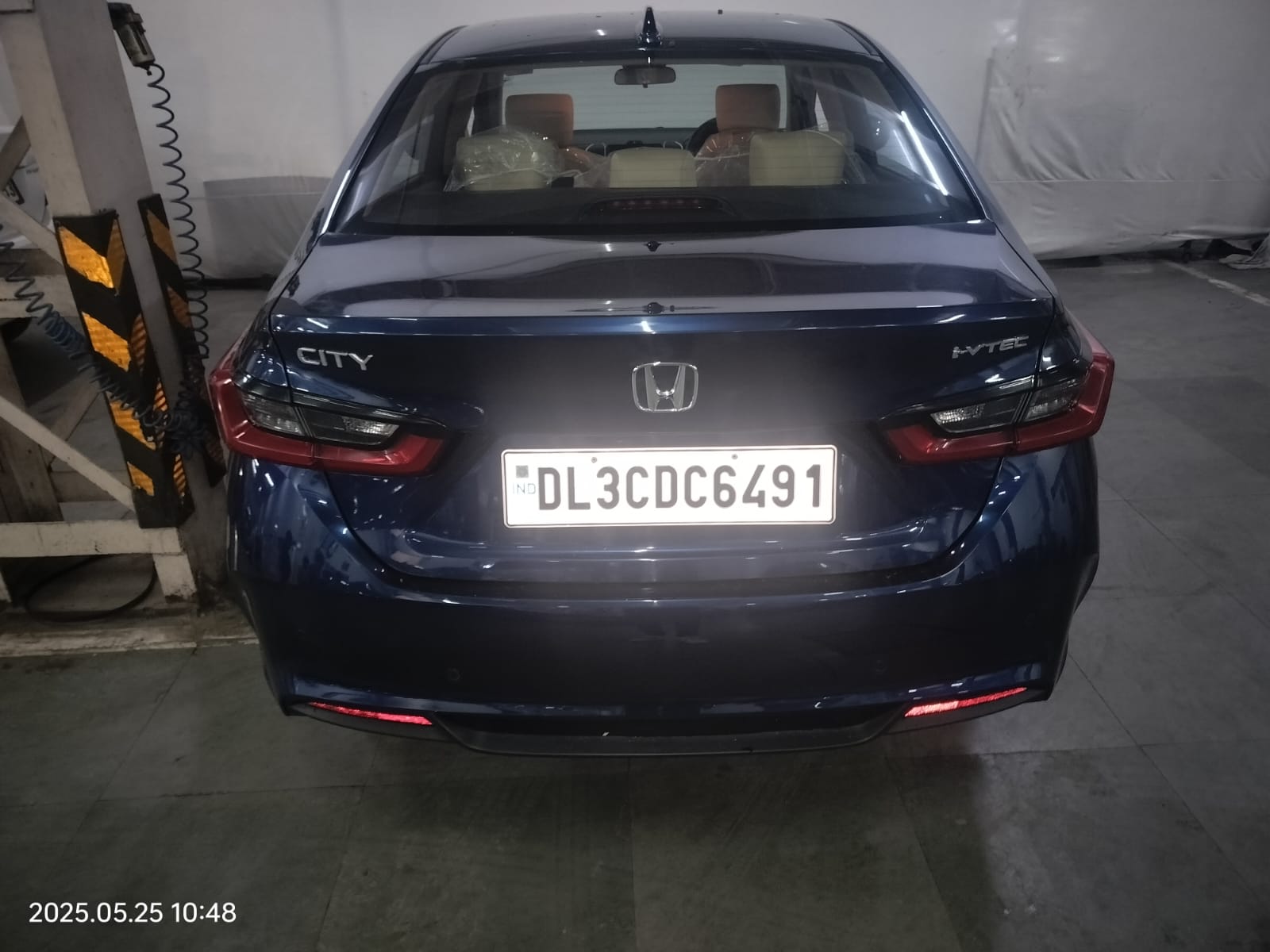 rear view of a Honda City in a garage