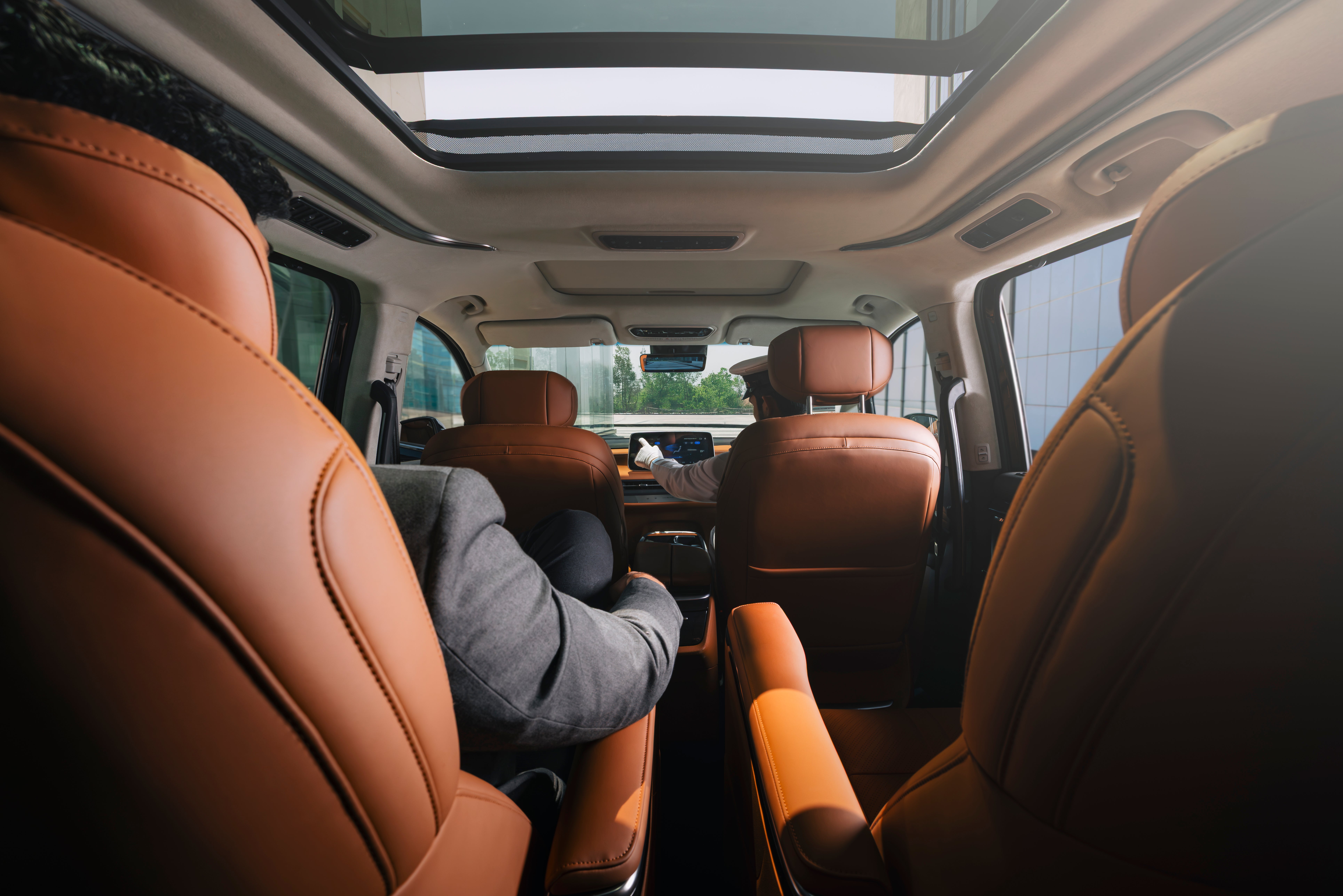 interior view of an MG M9 with panoramic sunroof and brown leather seats