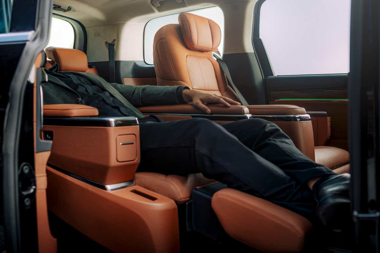 Rear seat interior of a MG M9 showcasing luxurious reclined seating