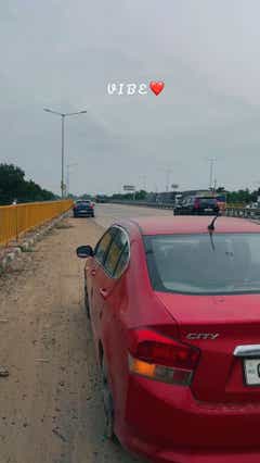 Rear view of a Honda City on a roadside