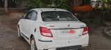 rear three-quarter of a Arctic White Maruti Suzuki Dzire 2018-2023