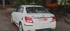 rear three-quarter of a Arctic White Maruti Suzuki Dzire 2018-2023