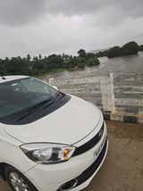 Front quarter view of a Pristine White Tata Tiago on a bridge