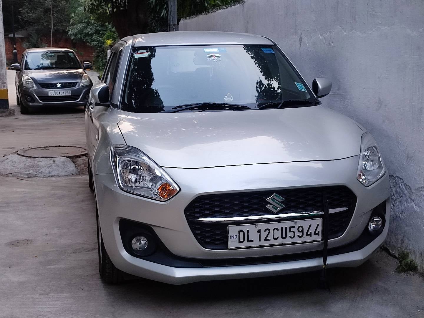 front view of a Metallic silky silver Maruti Suzuki Swift 2021 - 2023