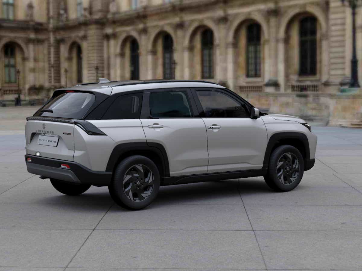 rear three-quarter view of a Splendid Silver with Bluish Black Roof Maruti Suzuki Victoris
