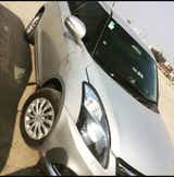 front three-quarter view of a Splendid Silver Maruti Suzuki Dzire 2018-2023