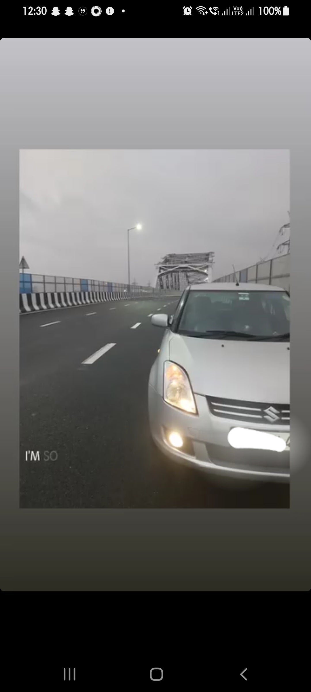 Front view of a Maruti Suzuki Dzire on a city bridge